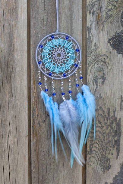 istock Handmade dream catcher with feathers threads and beads rope hanging 1253429533