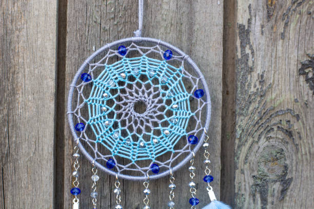 istock Handmade dream catcher with feathers threads and beads rope hanging 1253429544