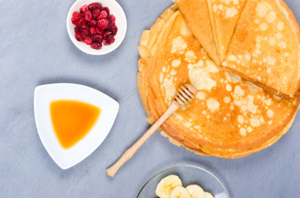 istock Pancakes with berries and honey for breakfast on white gray table 1253429567