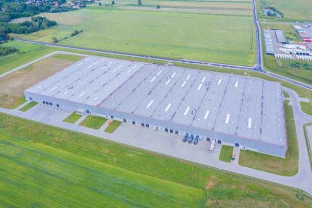 istock Aerial Shot of Industrial Loading Area where Many Trucks Are Unloading Merchandise. 1253429685