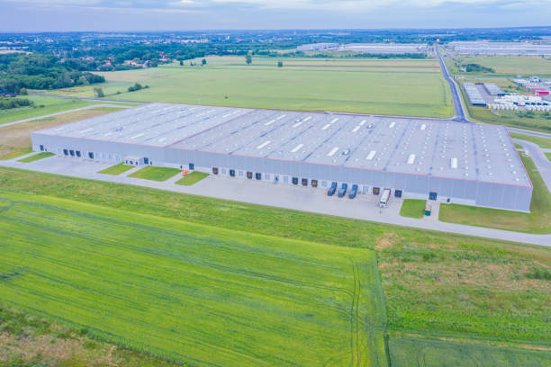 istock Aerial Shot of Industrial Loading Area where Many Trucks Are Unloading Merchandise. 1253429764