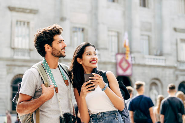 istock Young tourists exploring Barcelona with help of smart phone 1253430979