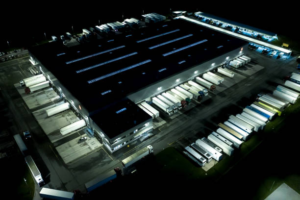 istock Night Modern logistics center, white van and trailers standingon ramp. Aerial View 1253431516
