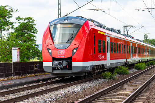 Koblenz Germany, 22 June 2020. An electric passenger train belonging to the Deutsche Bahn AG carrier, arriving at a small railway station in Koblenz in western Germany, visible railway traction.