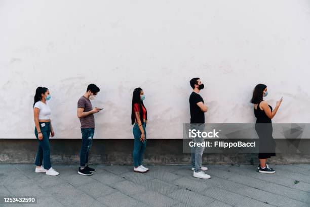 People Waiting In Line To Enter In A Store Social Distancing Concept Stock Photo - Download Image Now