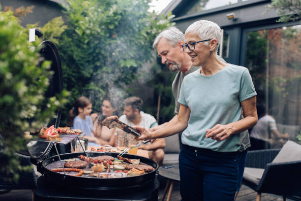 istock Senior couple making barbecue party at the backyard 1253434139