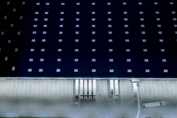 istock Night Loading dock at a warehouse. modern logistics center. docking stations of a distribution center 1253434754