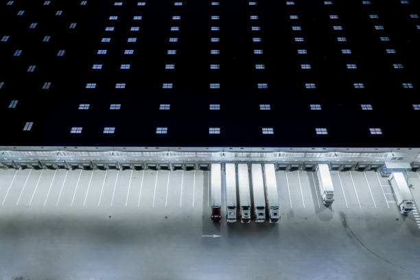 istock Night Loading dock at a warehouse. modern logistics center. docking stations of a distribution center 1253435308