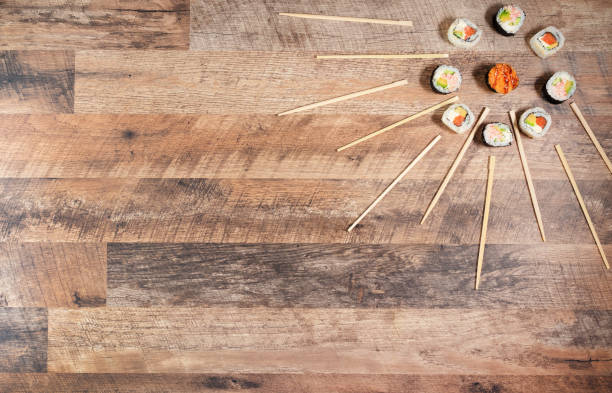 Sushi roll set with chopsticks. Japan sun concept. Place for your text or logo.