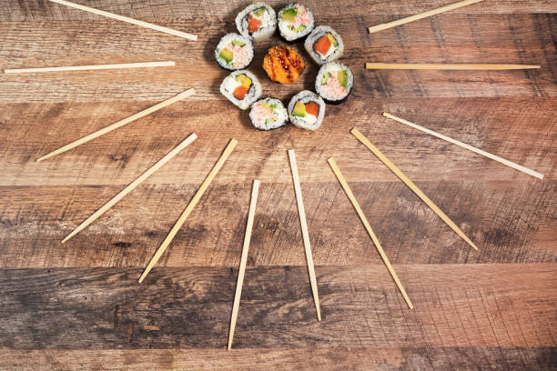 Sushi roll set with chopsticks. Japan sun concept. Place for your text or logo.