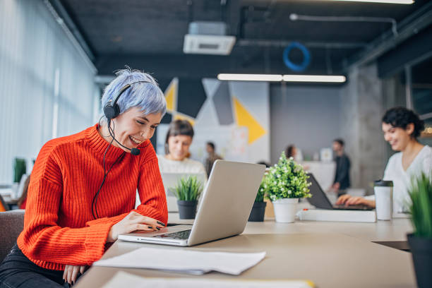 istock Woman working on laptop in modern office 1253439610