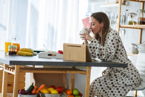 istock Having a morning coffee with a friend over a video call 1253439864