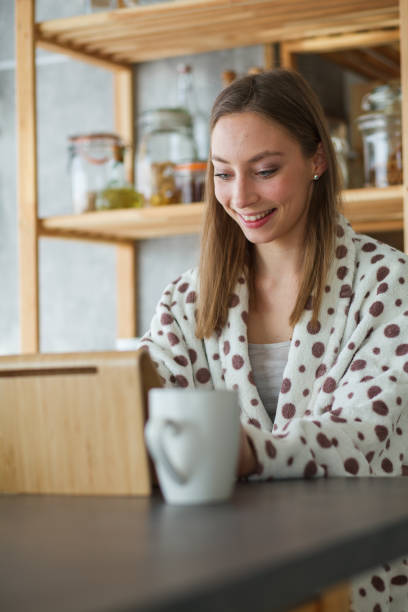 istock Young woman smiling while chatting over a video call 1253439871