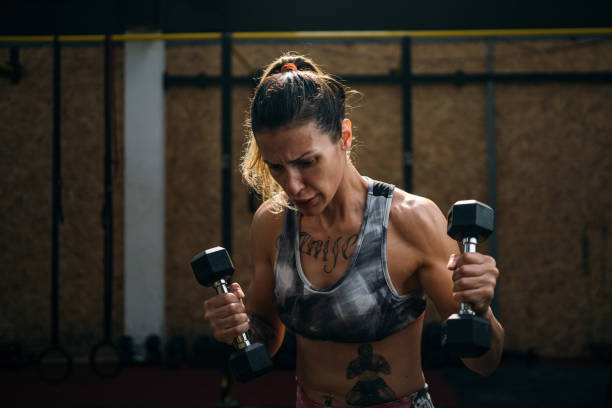istock Woman working out with dumbbell 1253441385
