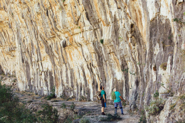 istock Senior man with a rope preparing for climbing on the rock. 1253446671