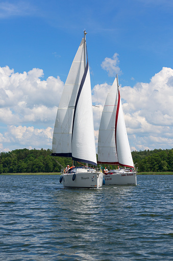 Masuria, Poland - June 24, 2020 : Lake in Polish Masuria, sailing yachts on a sunny day