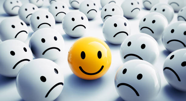 Yellow smiling Face in a Crowd of white Faces