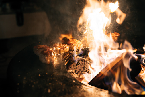 Steaks are grilled in the flames of fire. High quality photo