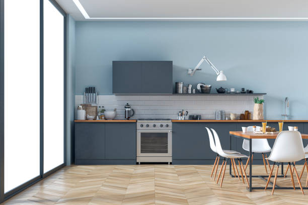 Modern kitchen and dining room stock photo Empty anthracite modern kitchen with appliances, dining table and windows in the background on hardwood floor. Slight cross process added. 3D rendered image. blue interiors stock pictures, royalty-free photos & images