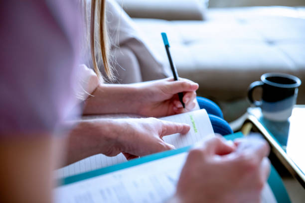 istock Schoolgirl doing Homework at home 1253450341