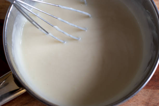 istock Making white savoury sauce at home 1253450370
