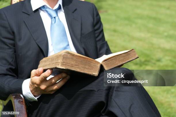 Businessman Reading An Old Book And Relaxing In The Garden Closeup Stock Photo - Download Image Now