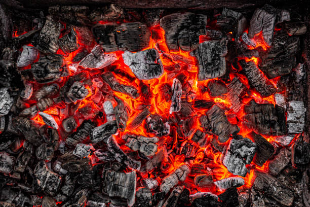 istock Hot white and black coals smolder in the grill 1253454694