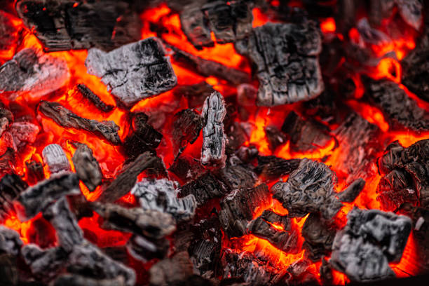 istock Hot white and black coals smolder in the grill 1253454918
