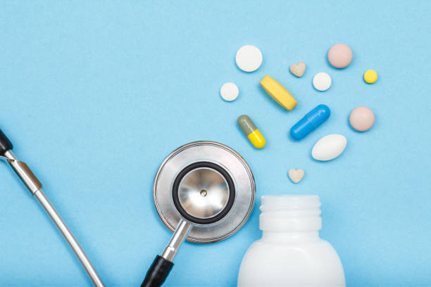 istock White bottle with different pills, capsules and phonendoscope 1253456011