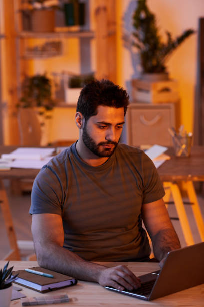 istock Beraded Man Working Late at Home 1253456160