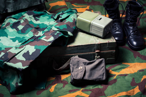 istock Vintage military equipment on a army tent fabric 1253456821