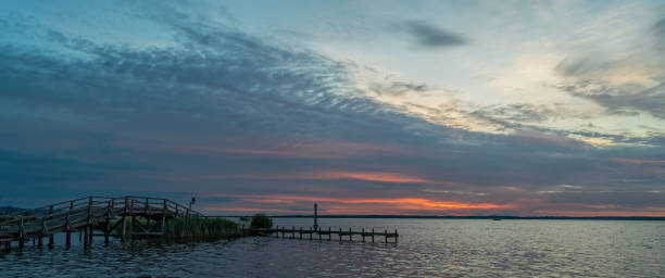 istock Bridge and promenade with majestic cloudscape at sunset 1253457505