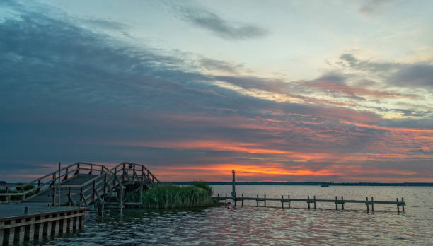 istock Bridge and promenade with majestic cloudscape at sunset 1253457631