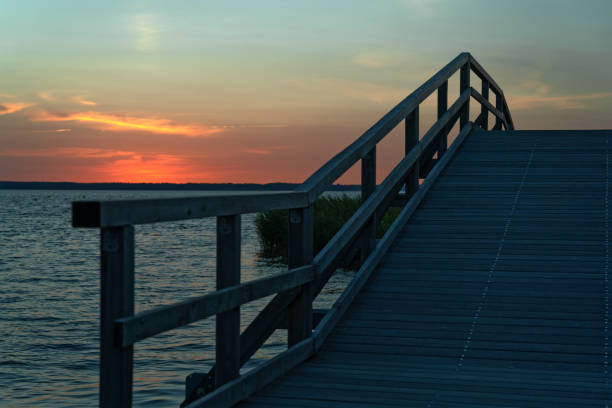 istock Bridge and promenade with majestic cloudscape at sunset 1253458486