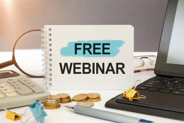 istock Desktop with documents, calculator and notebook. Inscription free webinar 1253458736