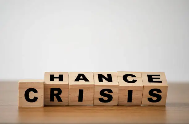 flipping wooden cubes for change wording" Crisis "  to " Chance".  Mindset is important for human development.