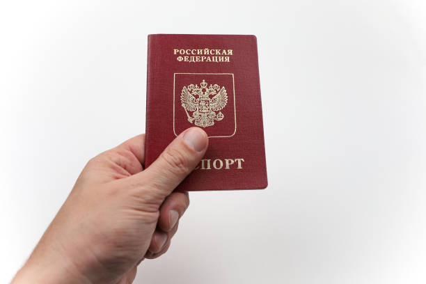 istock Hand with Russian passport on white background. 1253459919
