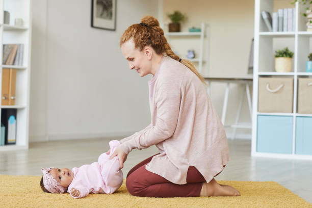 istock Woman exercising with baby 1253459936