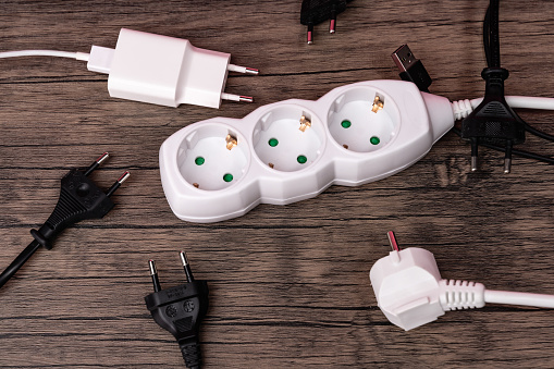 White extension cord with a lot of plugs. The scene is situated in controlled studio environment. Photo is taken with SONY AIII camera