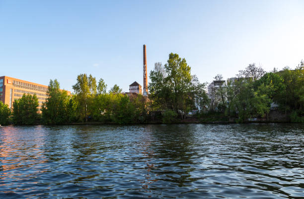 istock Low angle from a river showing trees and buildings 1253460771