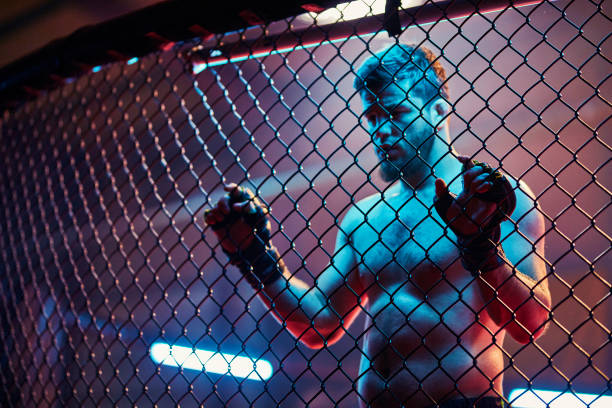 istock MMA fighter leaning on a fighting cage. Ready for a challenge 1253461566