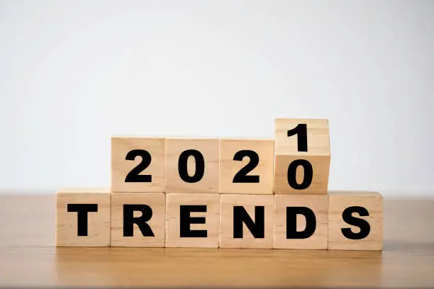 Photo of flipping 2020 to 2021 trends print screen on wooden block cubes. New idea business fashion popular and relevant topics.
