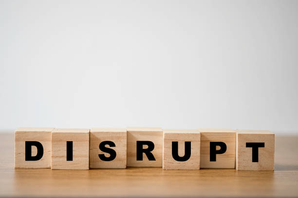 istock Disrupt wording print screen on wooden cubes block on table. 1253461884
