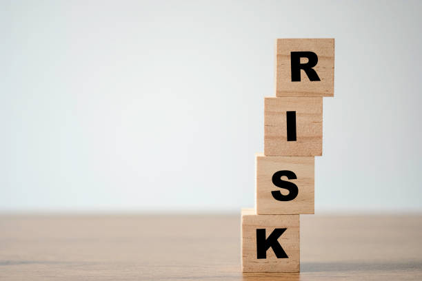 istock Stacking of wooden which print screen risk wording on the table with copy space. risk management concept. 1253462129