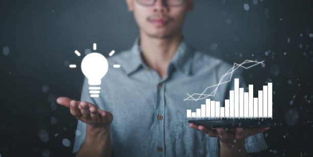 A man with a light bulb graphics in his hand and the other side holds white stock graphics, concept idea, concept innovation.