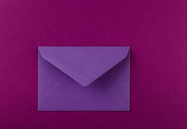 istock Colorful envelope on a purple background. 1253463210