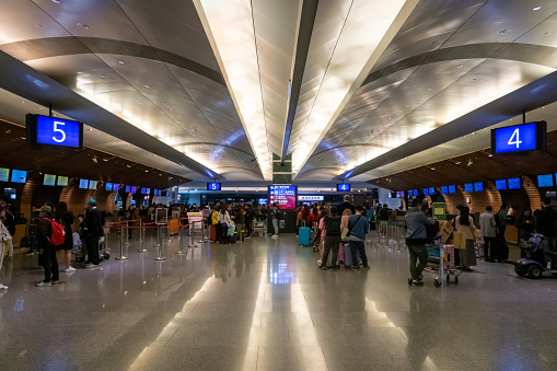 Taipei, Taiwan - February 2019: Taipei Taoyuan Airport architecture and passengers inside. Taipei Taoyuan airport is one of the busiest airports in the world.