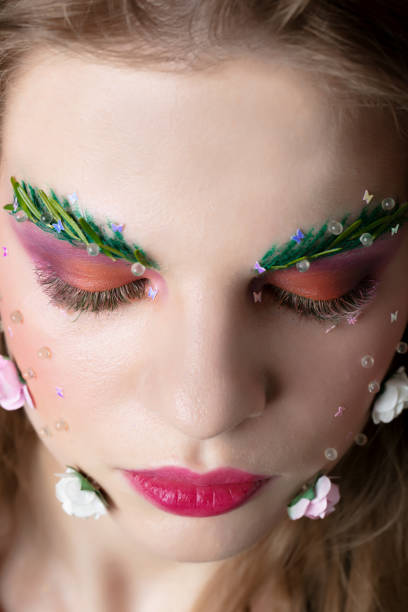 istock Beautiful girl with makeup eyebrows and eyelashes 1253463394