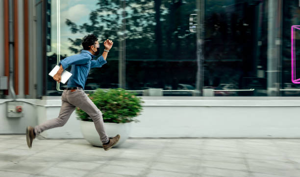 istock The Man hurry running passing showcase, He live in urban. 1253463585