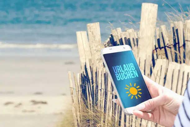 Beach, smartphone and holiday booking